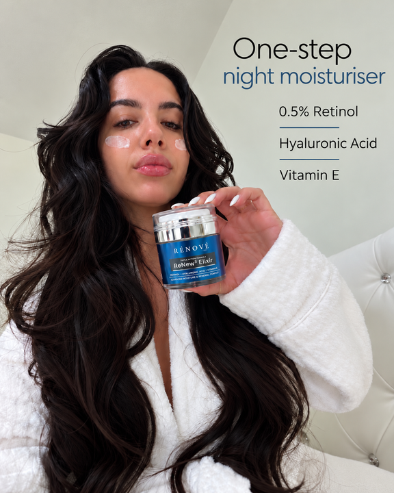 Woman holding Rénové ReNew³ Elixir night moisturiser with cream dotted on her cheeks